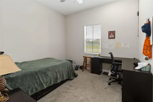 a bedroom with a bed and dresser