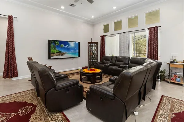 a living room with furniture a large window and a flat screen tv