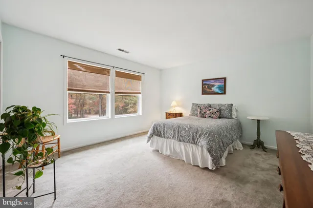 a spacious bedroom with a bed and a window