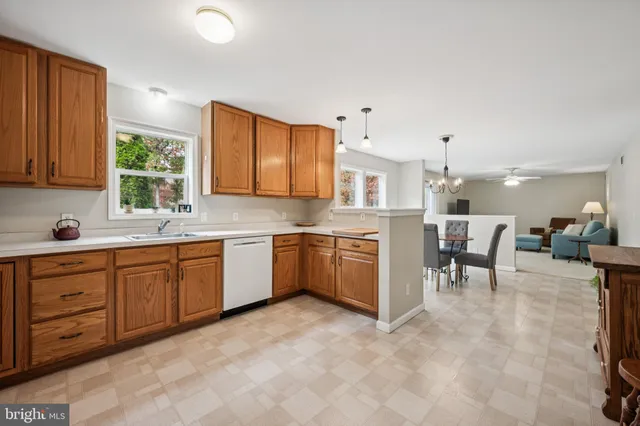 a large kitchen with a large counter top space appliances and cabinets