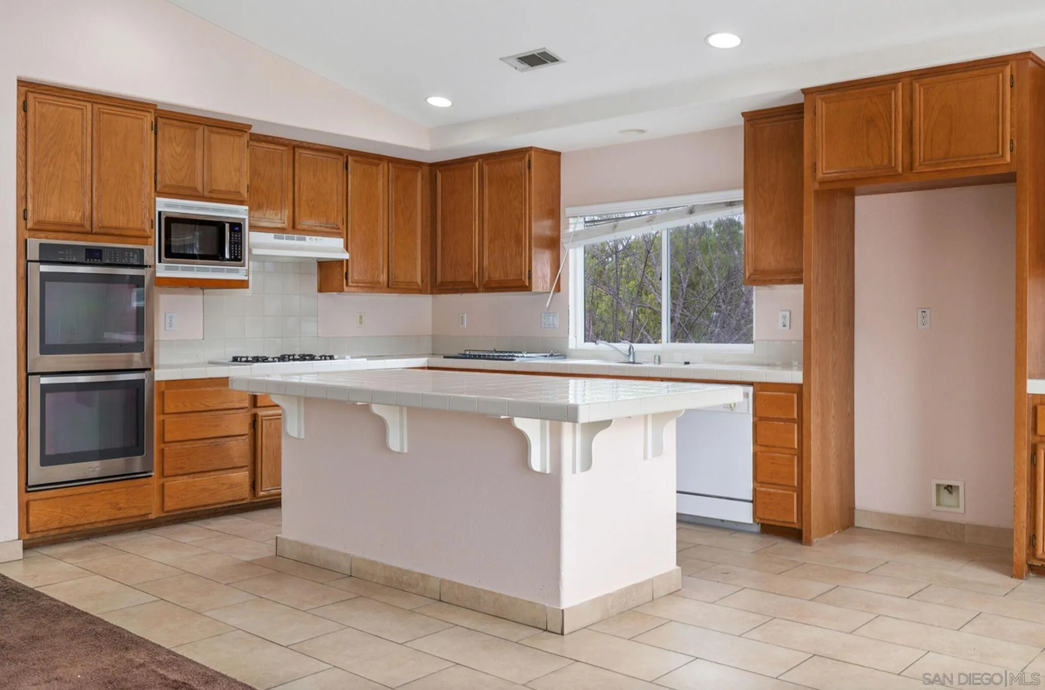 2269 Pointe Parkway Spring Valley, CA 91978 - Photo 11 of 35 a kitchen with stainless steel appliances granite countertop a refrigerator and a stove top oven