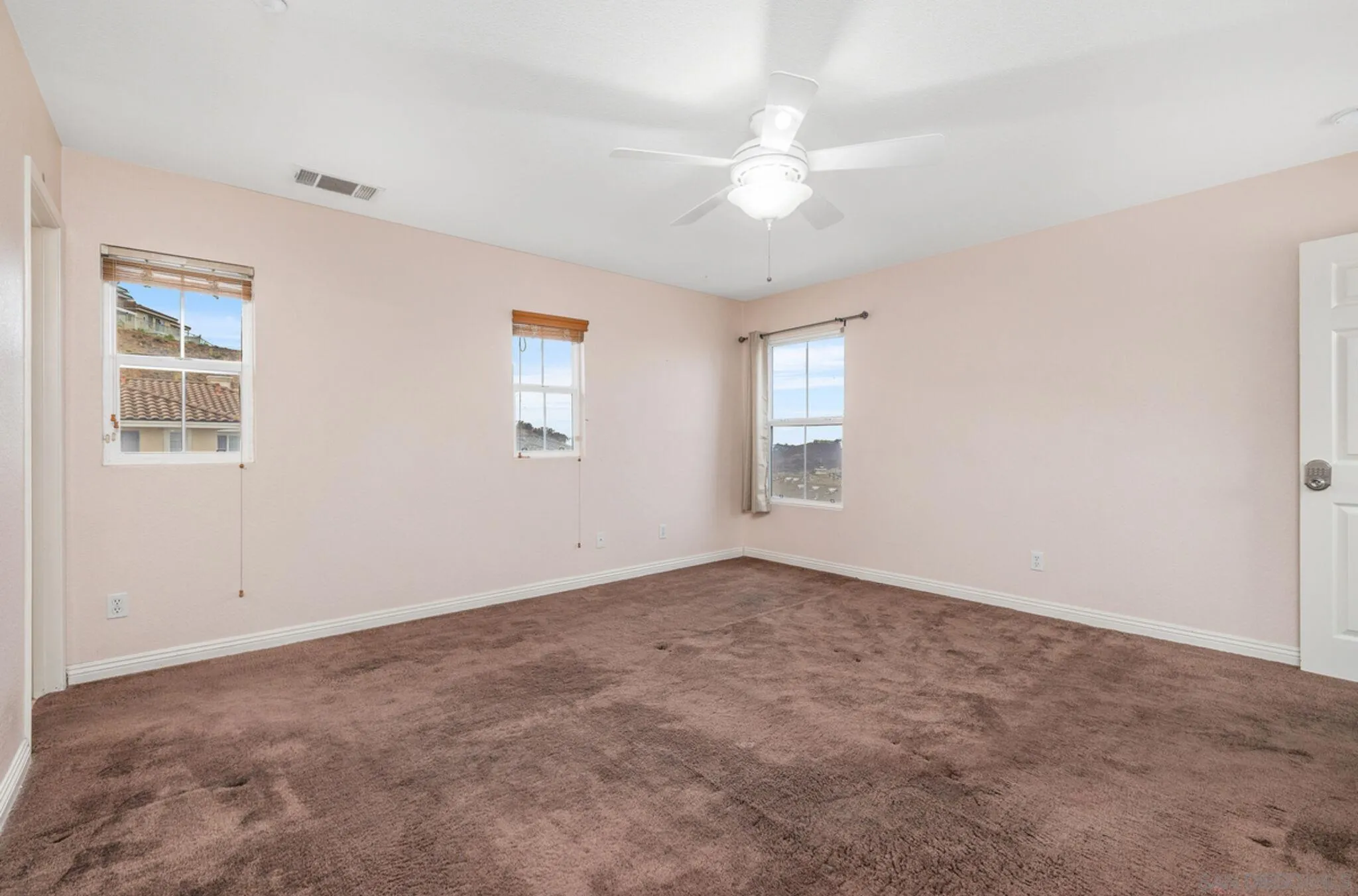 2269 Pointe Parkway Spring Valley, CA 91978 - Photo 21 of 35 an empty room with windows and fan