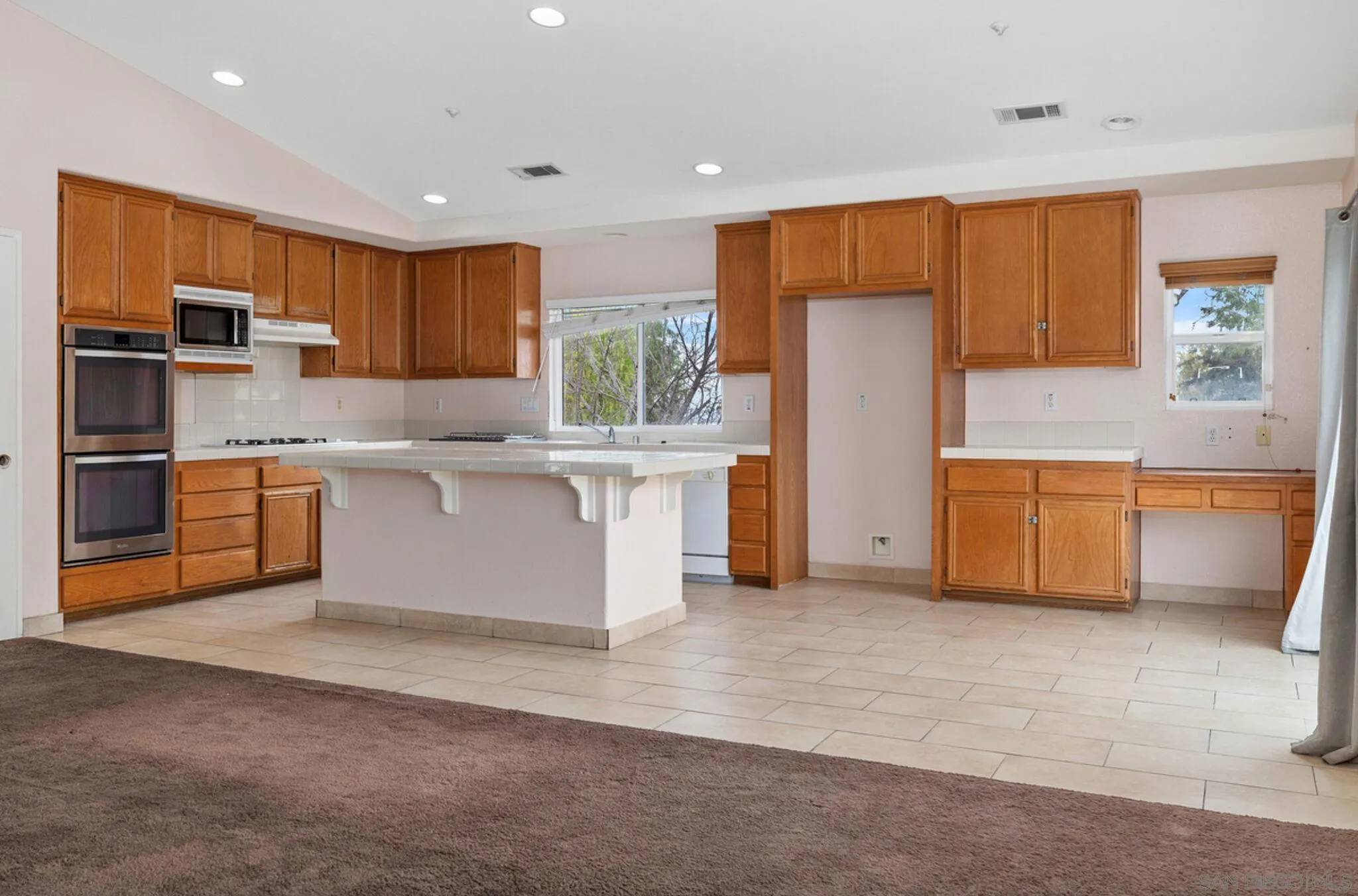 2269 Pointe Parkway Spring Valley, CA 91978 - Photo 10 of 35 a kitchen with stainless steel appliances granite countertop a refrigerator and a stove top oven
