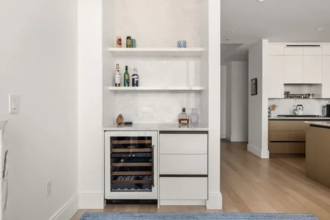 a kitchen with granite countertop a refrigerator and a stove