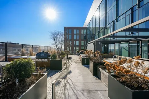 a view of a patio with couches a table and chairs and potted plants