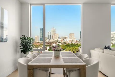 a view of a dining room with furniture and window