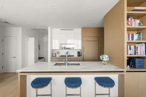 a kitchen with stainless steel appliances granite countertop a sink and a refrigerator