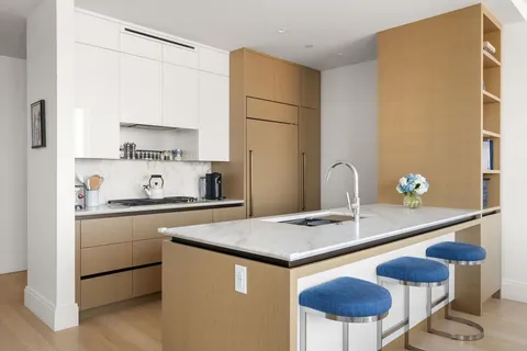 a kitchen with a table chairs stove and cabinets