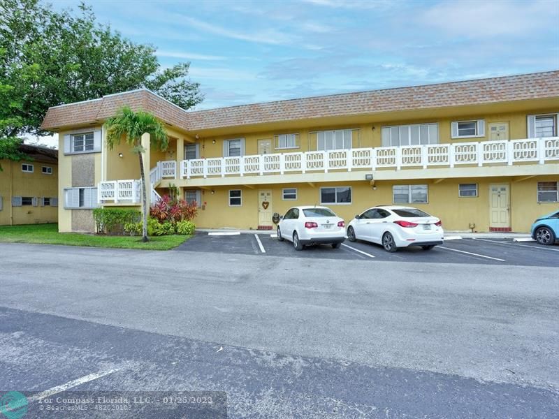 a couple of cars parked in front of a building