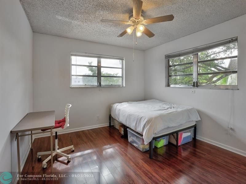 5160 Southwest 40th Avenue, Unit 29D Dania Beach, FL 33314 - Photo 11 of 31 a bedroom with a bed and a chandelier