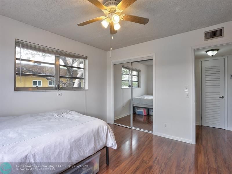 5160 Southwest 40th Avenue, Unit 29D Dania Beach, FL 33314 - Photo 12 of 31 a bedroom with a bed and a chandelier