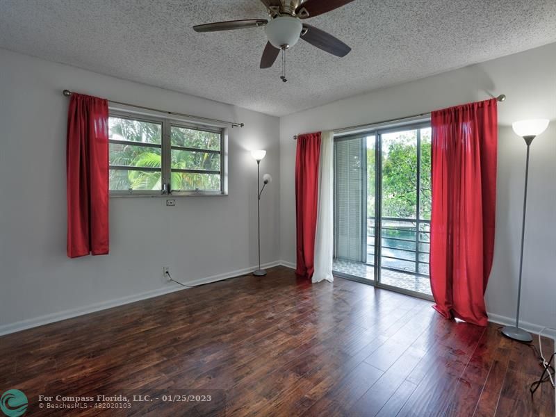 5160 Southwest 40th Avenue, Unit 29D Dania Beach, FL 33314 - Photo 14 of 31 a view of an empty room with wooden floor and a window