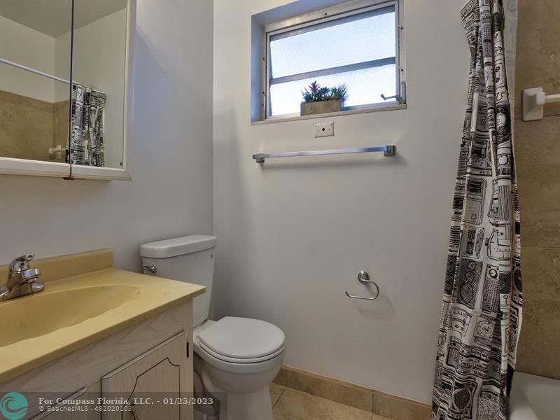 5160 Southwest 40th Avenue, Unit 29D Dania Beach, FL 33314 - Photo 17 of 31 a bathroom with a sink a toilet and a mirror