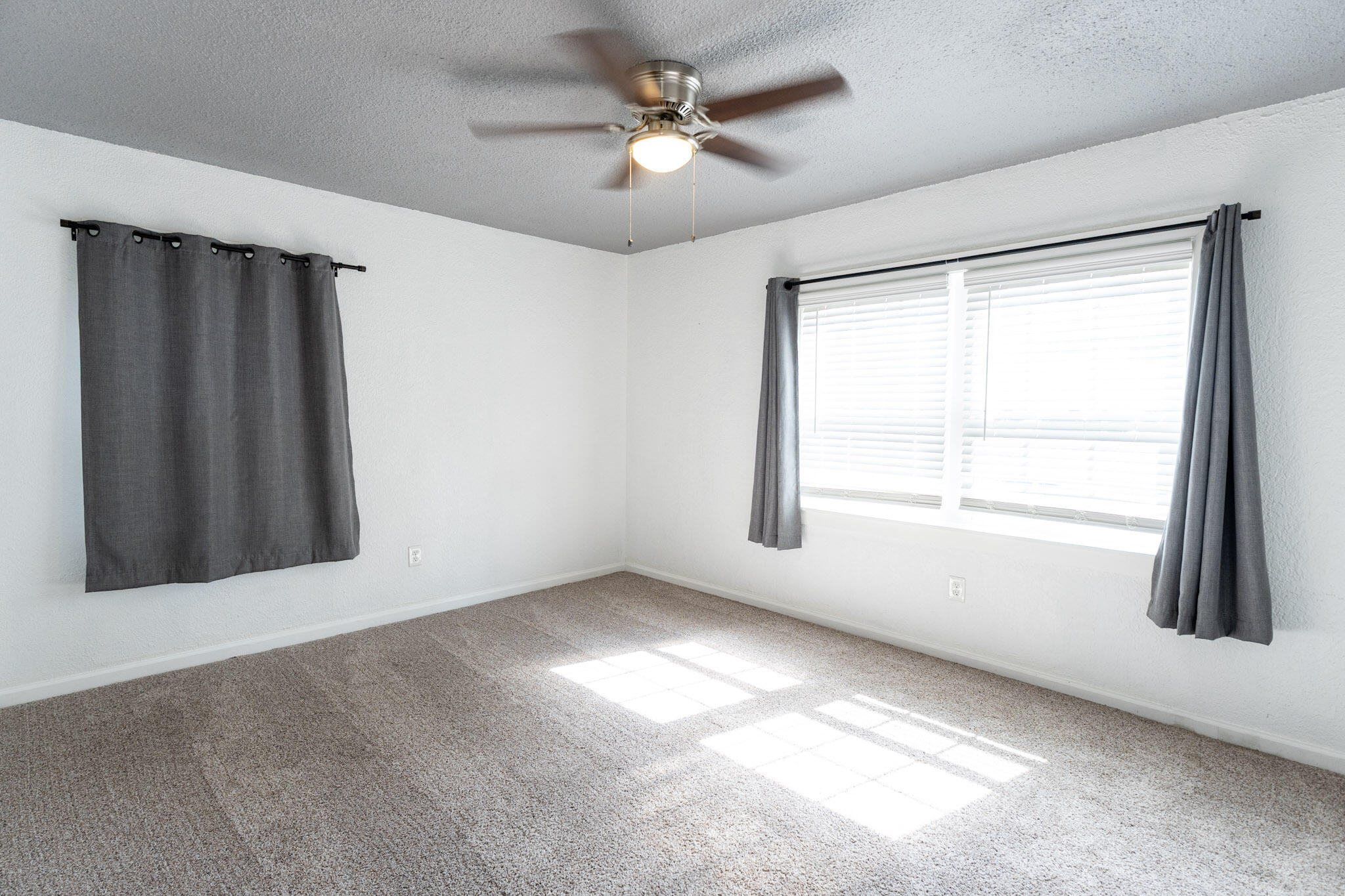 3006 36th Street Lubbock, TX 79413 - Photo 11 of 16 an empty room with windows and fan