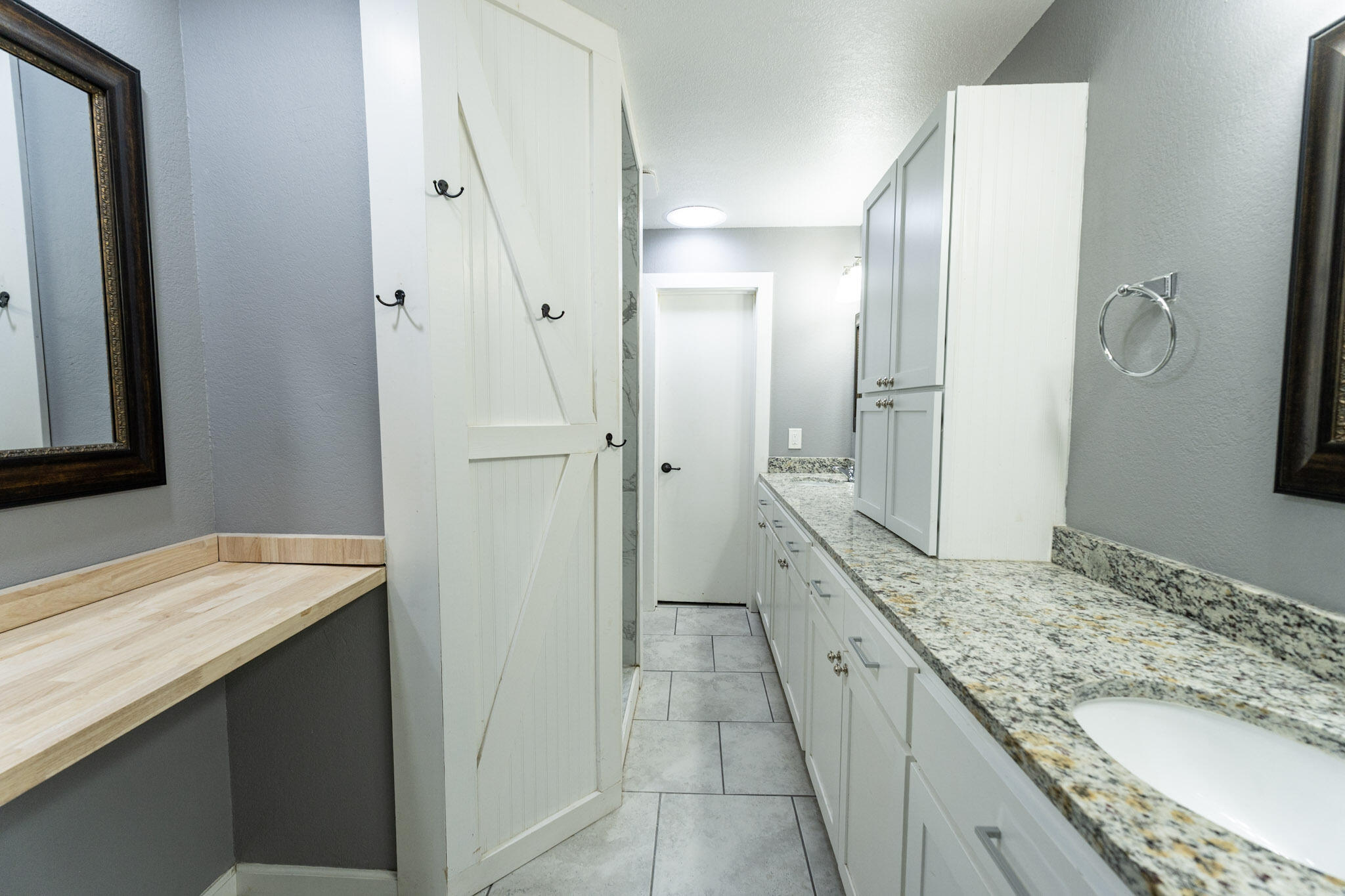 3006 36th Street Lubbock, TX 79413 - Photo 9 of 16 a bathroom with a granite countertop double vanity sink and mirror