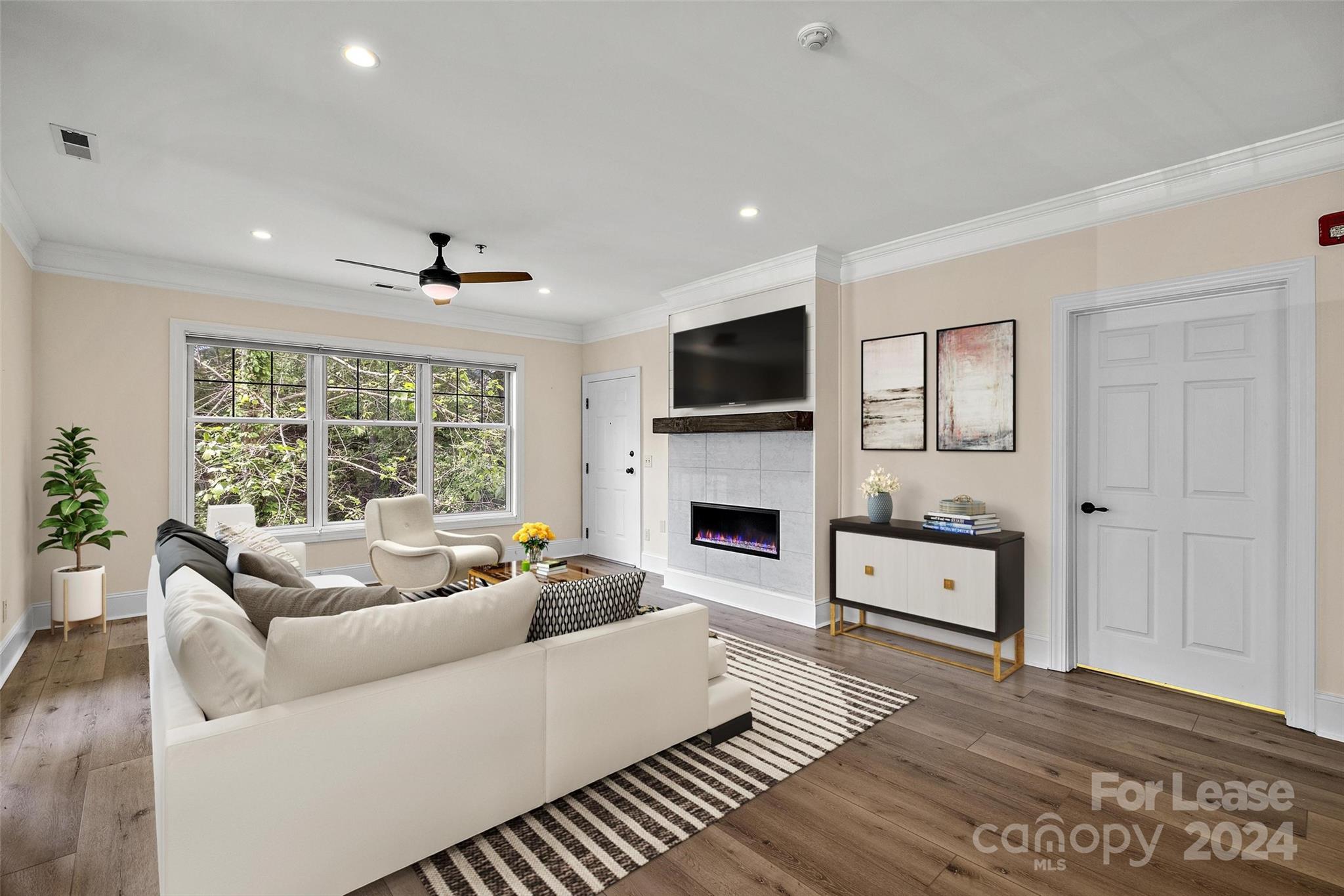 a living room with furniture fireplace and flat screen tv