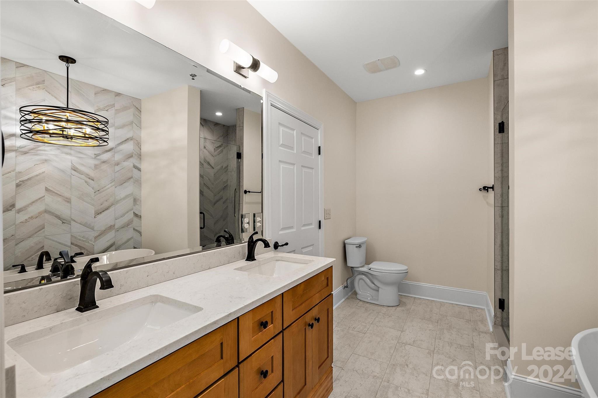 180 Gateway Drive Boone, NC 28607 - Photo 10 of 13 a bathroom with a granite countertop sink a toilet and a mirror