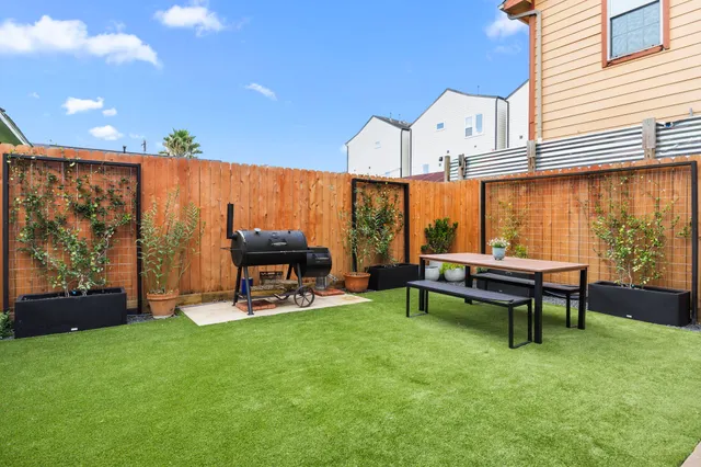 a view of a chairs and table in patio with a yard