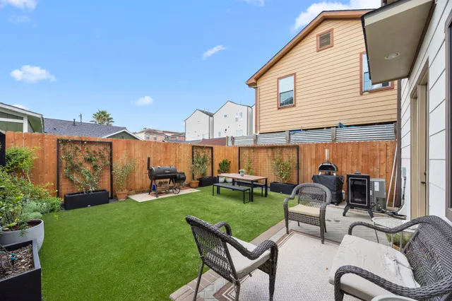 a view of a house with backyard sitting area and furniture