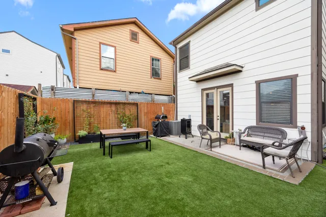 a backyard of a house with outdoor seating