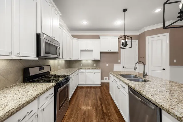 a kitchen with a sink stove and microwave