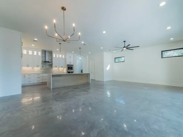 a view of a kitchen with a stove and a chandelier fan