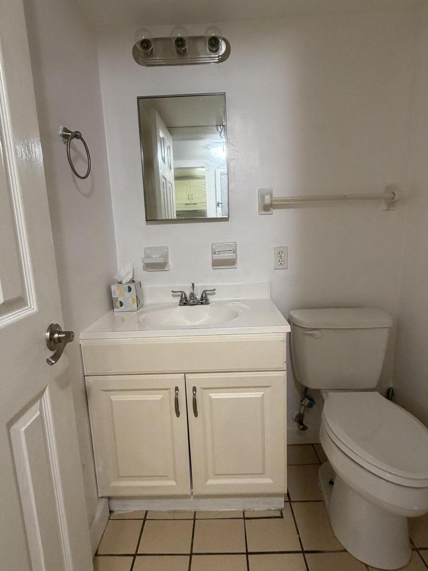 270 South Cypress Road, Unit 204 Pompano Beach, FL 33060 - Photo 13 of 14 a bathroom with a sink toilet and mirror