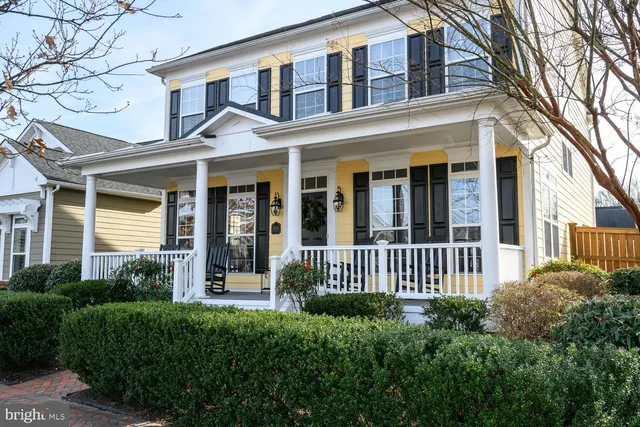 a living room with wooden floor and a rug