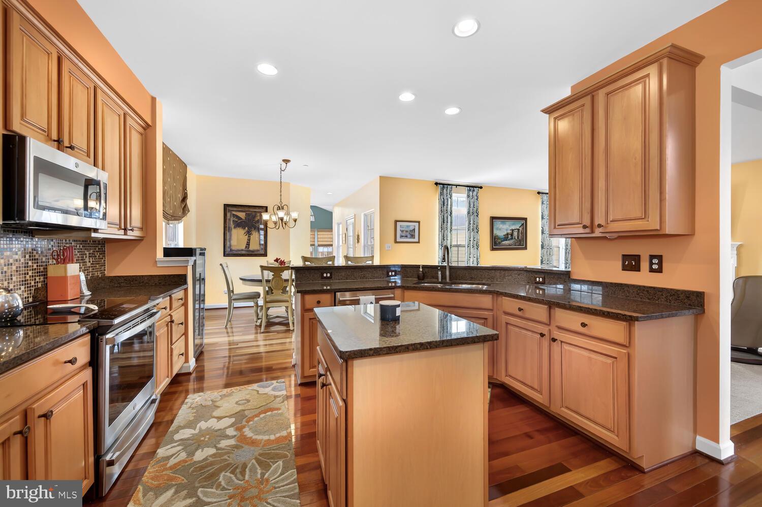 28241 Knapps Easton, MD 21601 - Photo 33 of 69 a kitchen with stainless steel appliances granite countertop a stove a sink dishwasher and a microwave oven with cabinets