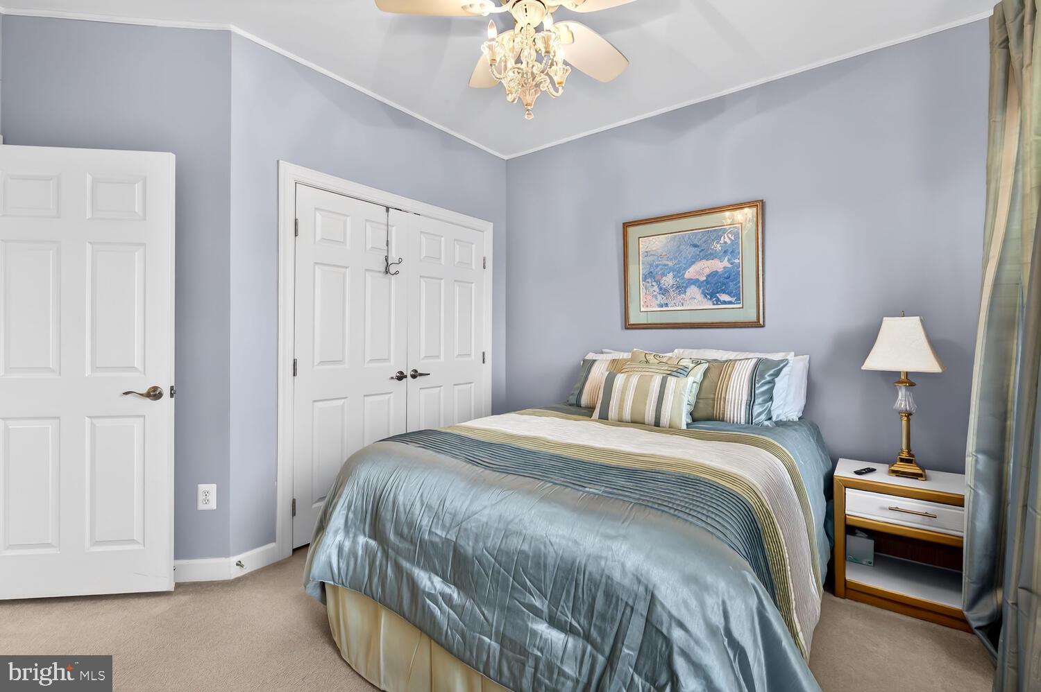 28241 Knapps Easton, MD 21601 - Photo 43 of 69 a bedroom with a bed and a chandelier