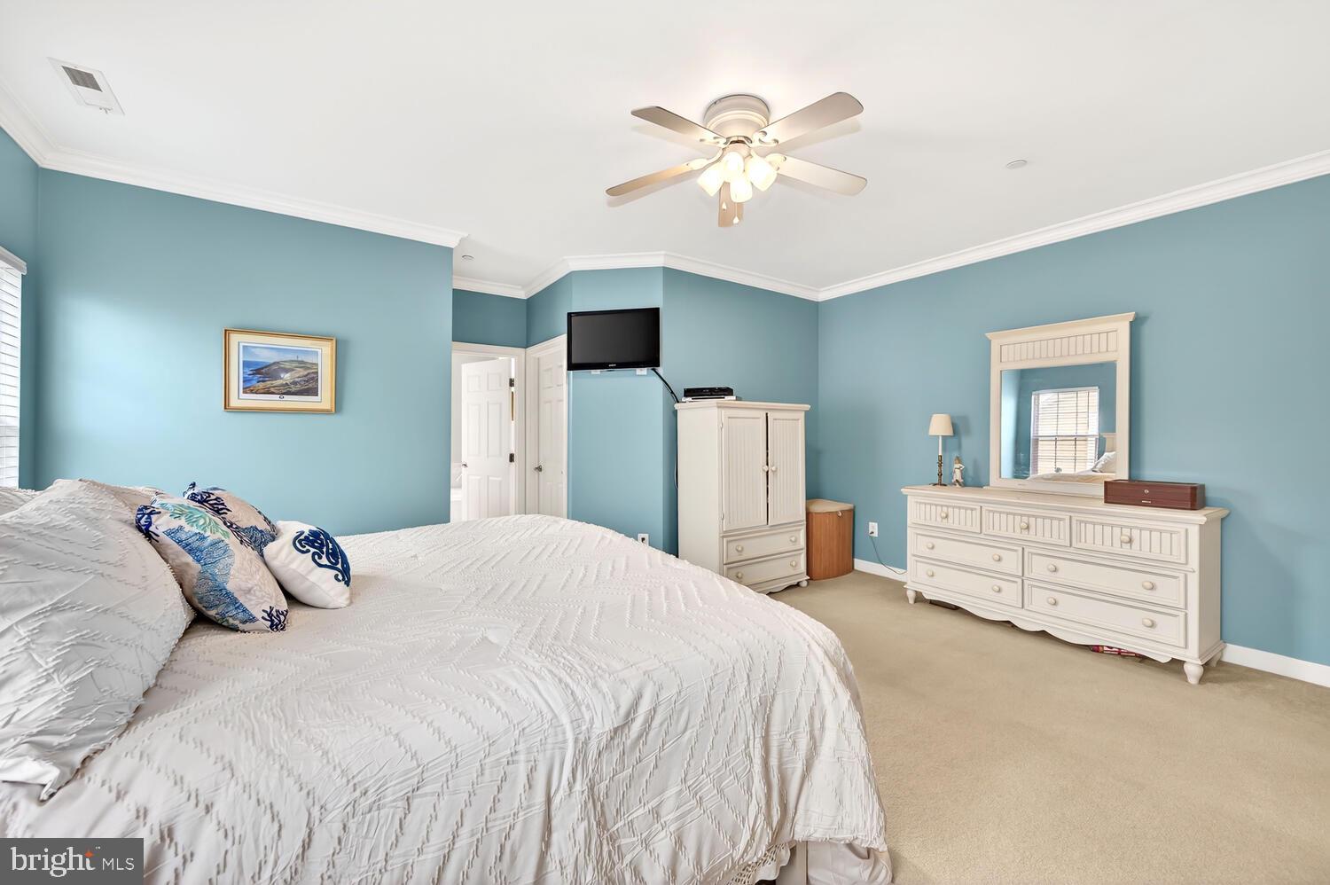 28241 Knapps Easton, MD 21601 - Photo 50 of 69 a bedroom with a bed and a chandelier