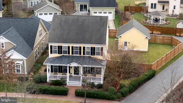 an aerial view of a house with garden space and street view