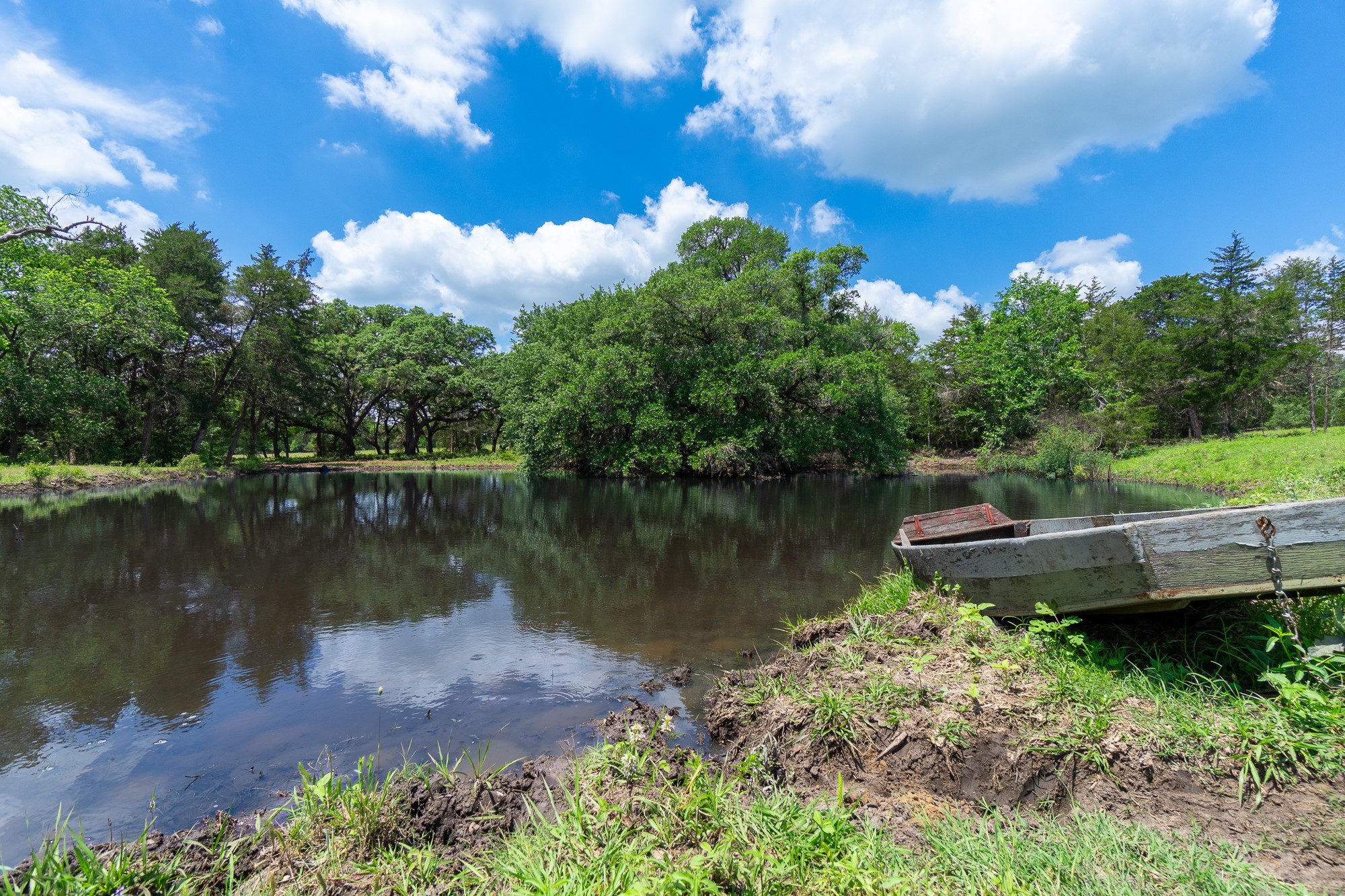 5018 Wolters Road Schulenburg, TX 78956 - Photo 19 of 39 a view of a lake with a house in the background