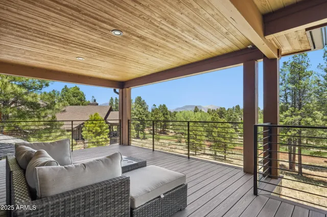 a balcony with furniture and wooden floor