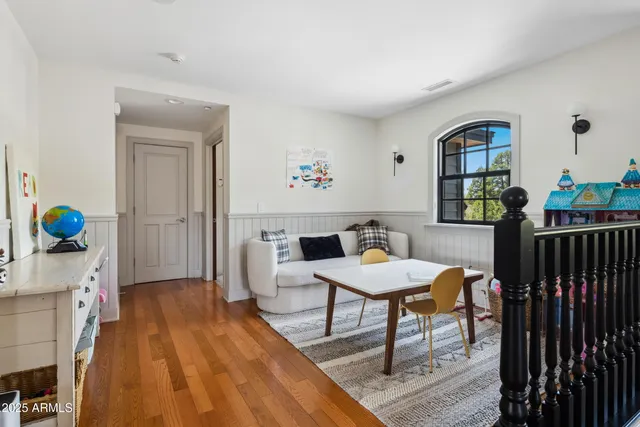a workspace room with furniture and wooden floor
