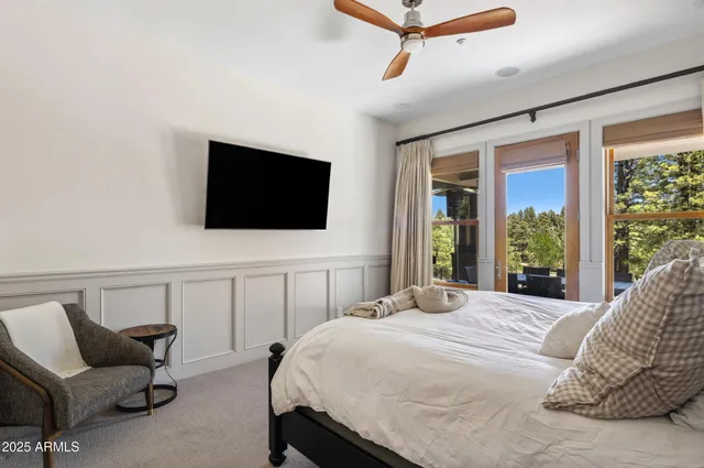 a bedroom with a bed and a flat screen tv