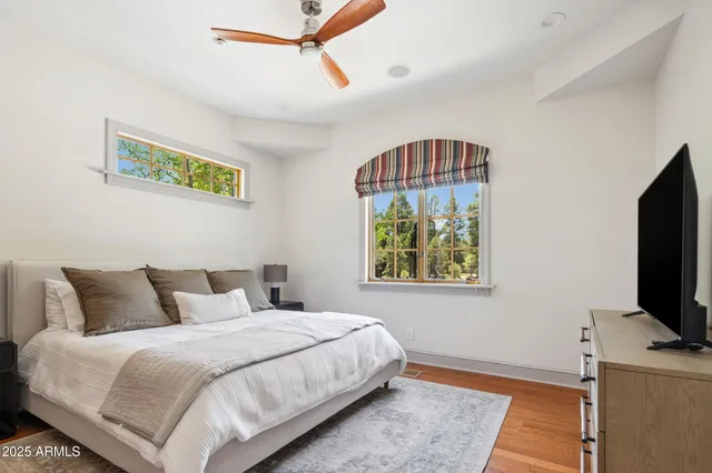 a bedroom with a bed and a flat screen tv