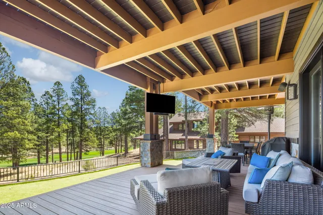 a view of a porch with furniture and wooden floor