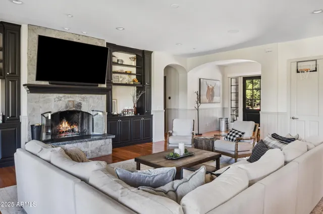 a living room with furniture fireplace and flat screen tv