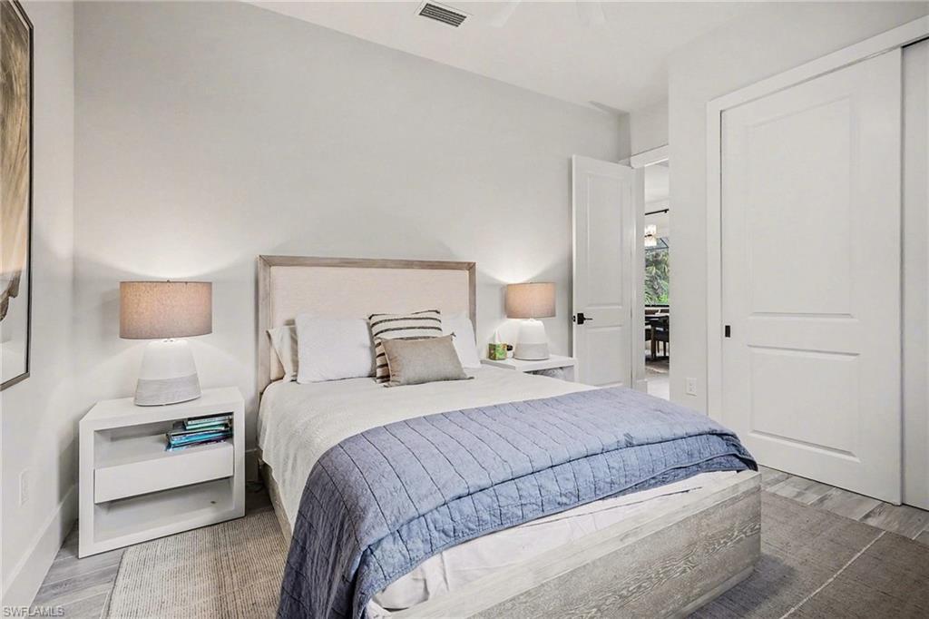 1720 21st Street Southwest Naples, FL 34117 - Photo 22 of 42 Bedroom featuring wood finished floors, a closet, and ceiling fan