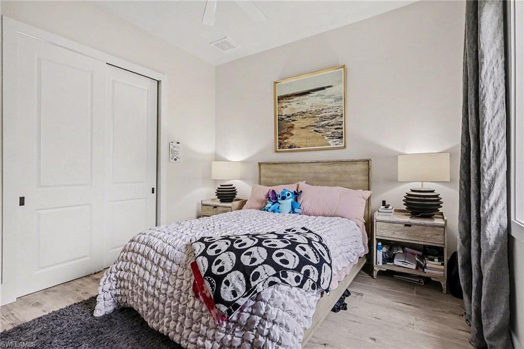 1720 21st Street Southwest Naples, FL 34117 - Photo 24 of 42 Bedroom featuring light wood-style flooring and a ceiling fan