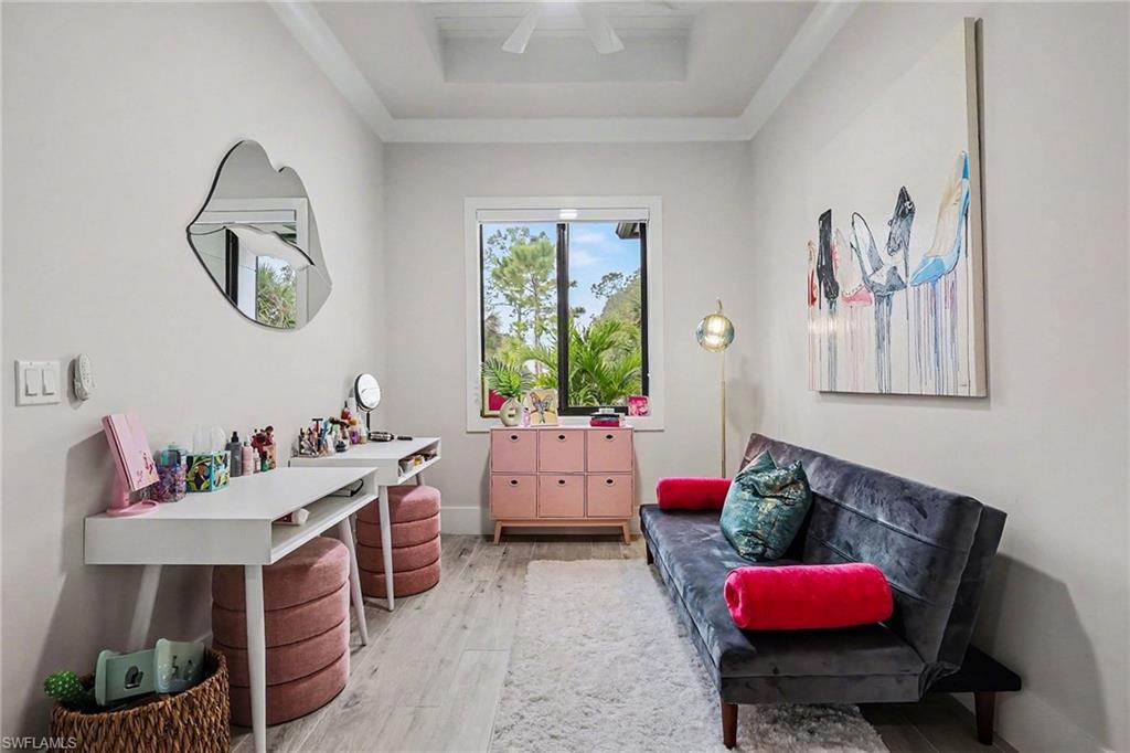 1720 21st Street Southwest Naples, FL 34117 - Photo 27 of 42 Living area featuring light wood-style flooring and ceiling fan