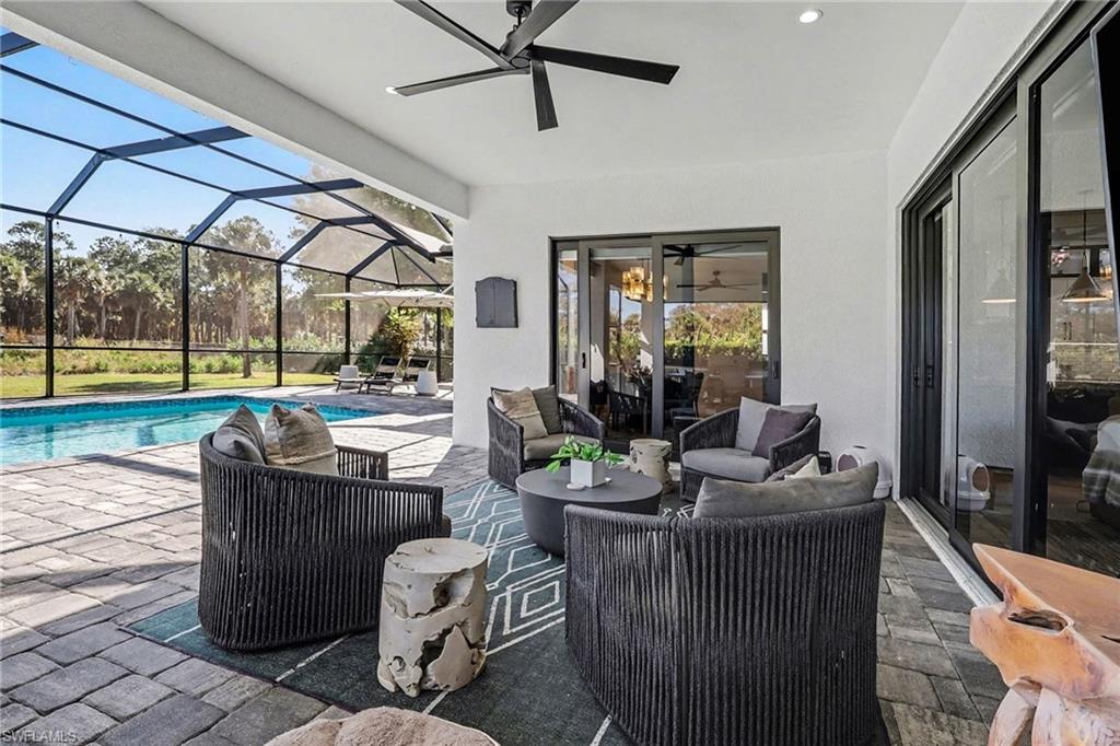 1720 21st Street Southwest Naples, FL 34117 - Photo 31 of 42 View of patio featuring outdoor lounge area, a sunroom, glass enclosure, ceiling fan, and an outdoor pool