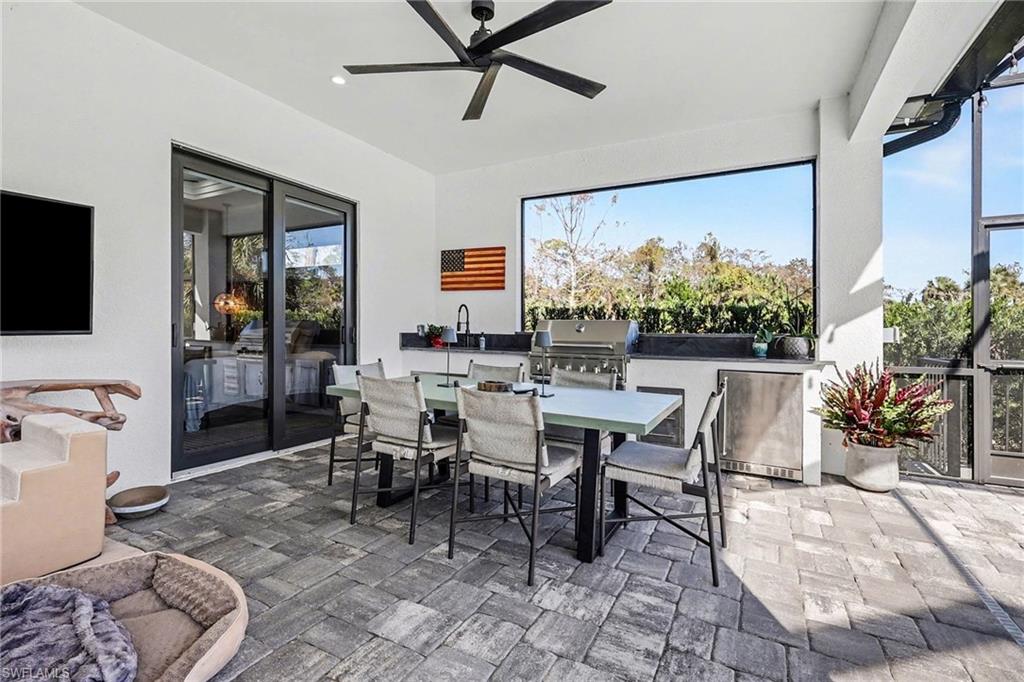 1720 21st Street Southwest Naples, FL 34117 - Photo 33 of 42 View of patio with exterior kitchen, a ceiling fan, and outdoor dining area