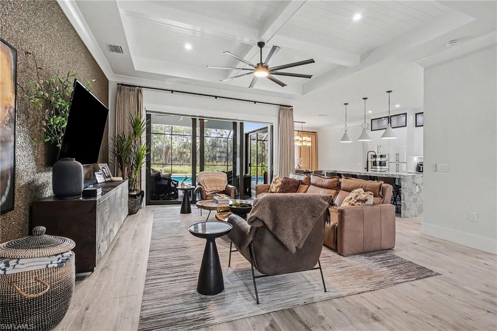 1720 21st Street Southwest Naples, FL 34117 - Photo 4 of 42 Living room with recessed lighting, light wood-style floors, a ceiling fan, beam ceiling, and coffered ceiling
