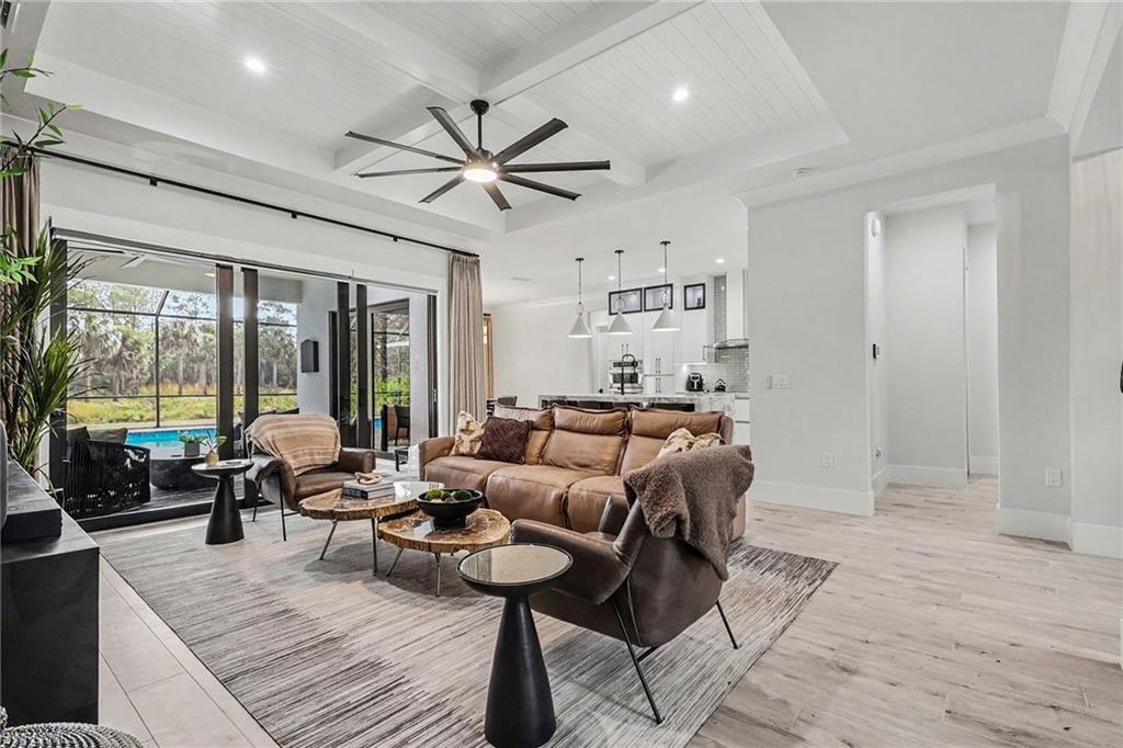 1720 21st Street Southwest Naples, FL 34117 - Photo 6 of 42 Living area featuring recessed lighting, ceiling fan, a wooden ceiling with exposed beams, light wood finished floors, and coffered ceiling