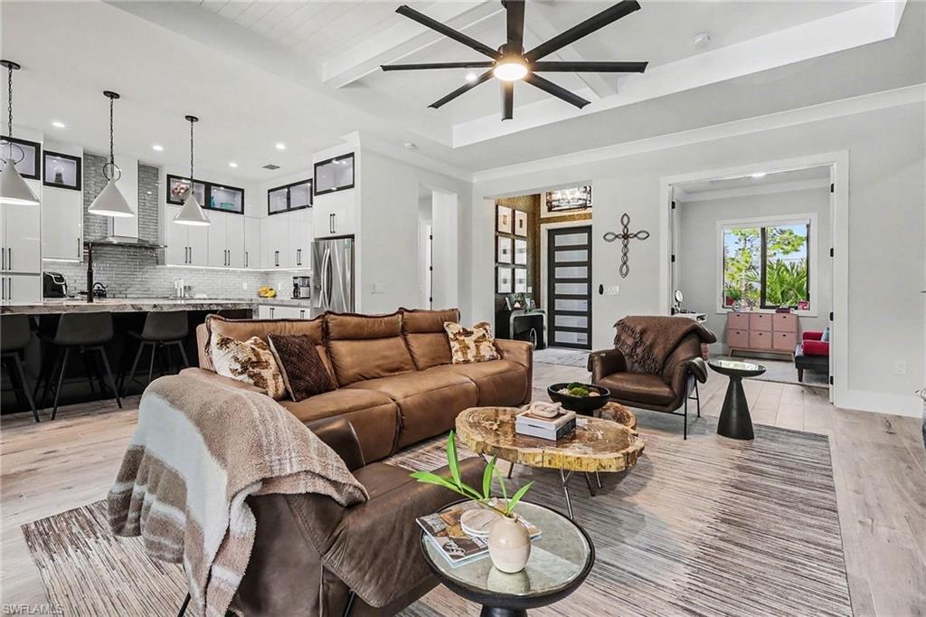 1720 21st Street Southwest Naples, FL 34117 - Photo 8 of 42 Living room featuring light wood finished floors, beam ceiling, recessed lighting, and ceiling fan