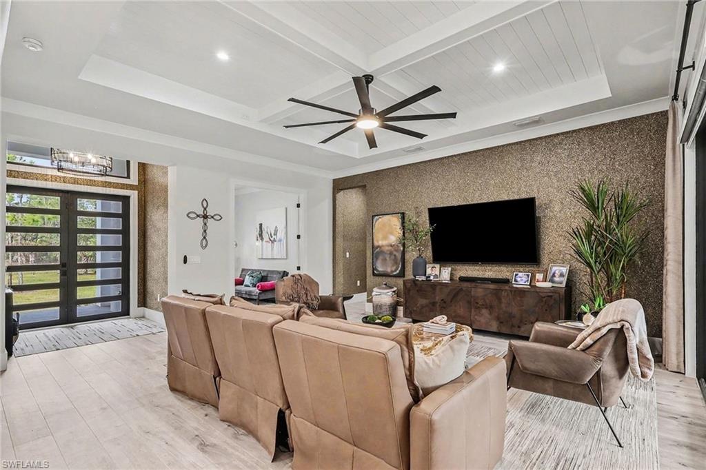 1720 21st Street Southwest Naples, FL 34117 - Photo 9 of 42 Living area featuring an accent wall, wallpapered walls, light wood-style flooring, french doors, and recessed lighting
