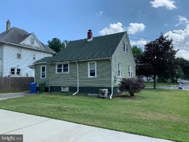 a front view of house with yard and outdoor seating