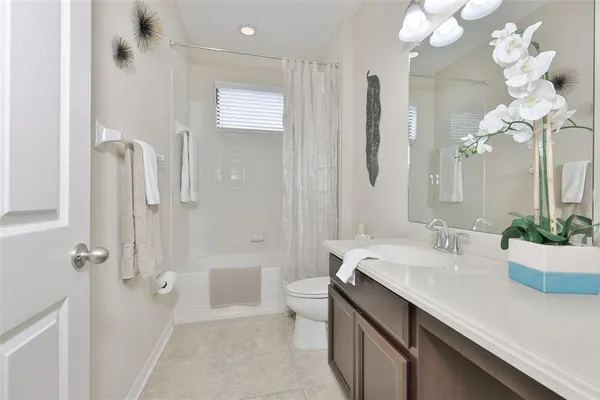 a white toilet sitting next to a bath tub